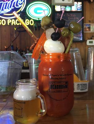 Pam's Bloody Mary in a tall glass, loaded with garnish, with a beer chaser beside it.